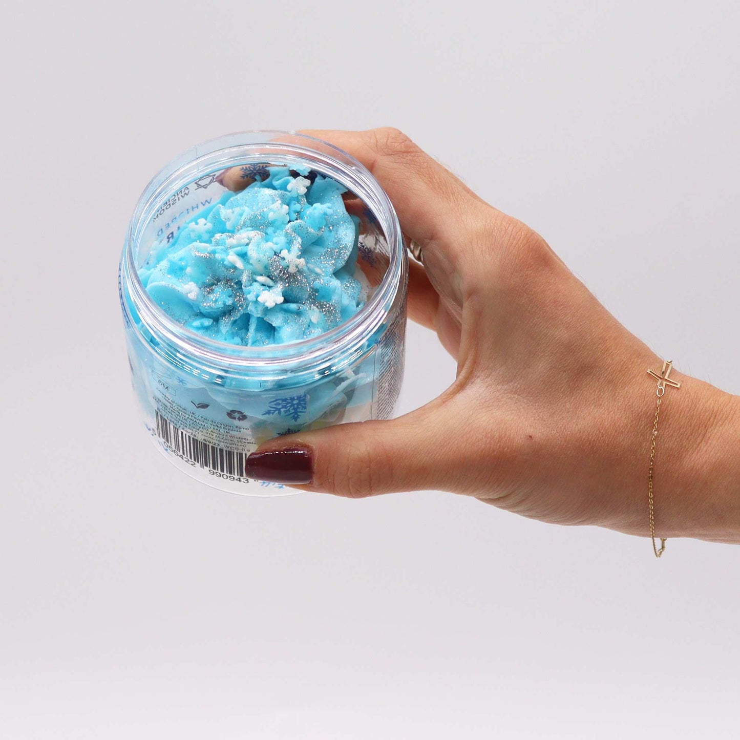 A hand holding the White Christmas Whipped Soap 120g, elegantly designed for at-home pampering during the holiday season, making it a delightful Christmas gift – Christmas Gift Home Fragrance.