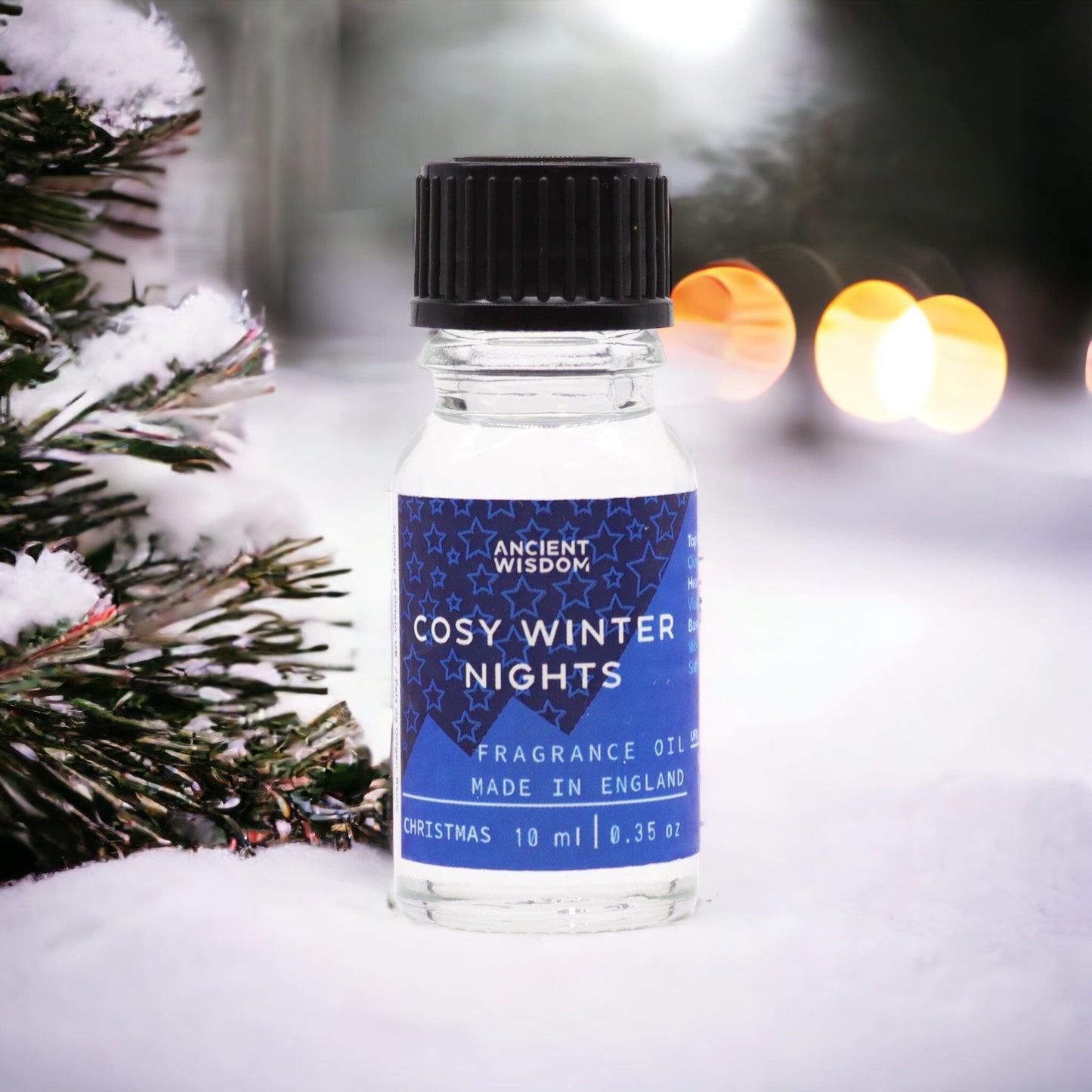 Cosy Winter Nights Essential Oil 10ml showcased amidst a snowy backdrop, embodying the essence of a festive fragrance. This luxurious winter spice blend with cinnamon and clove is perfect for gifting as a Christmas present or stocking filler, enhancing your home fragrance and creating a cosy pamper pack for aromatherapy lovers.