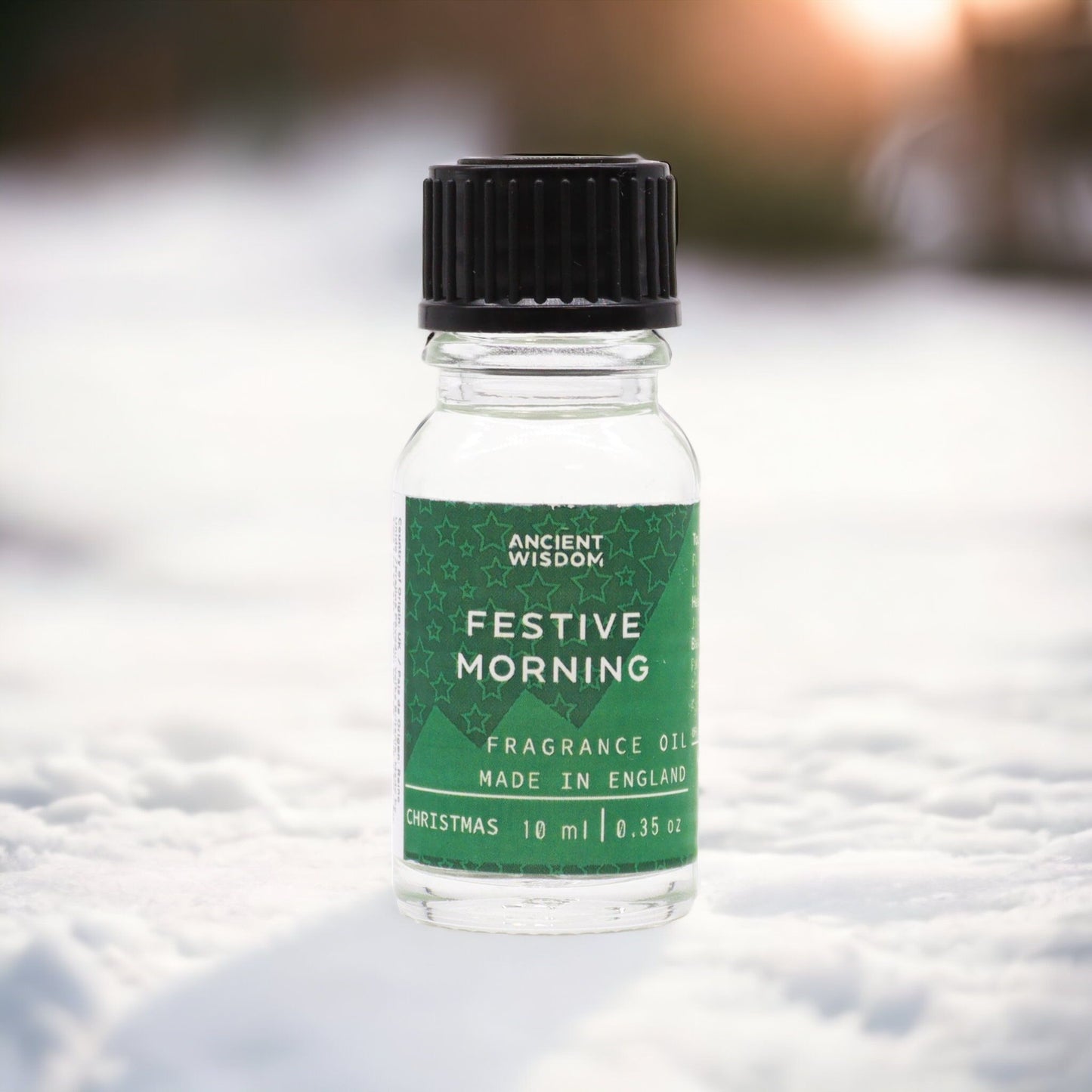 Festive Morning Fragrance Oil 10ml in a snowy backdrop, perfect as a Christmas gift or stocking filler. This festive fragrance brings warmth to your home with its winter spice notes, ideal for a pamper pack or aromatherapy. Enjoy the enchanting aroma of cinnamon orange and frankincense myrrh, making your festive season feel like a white Christmas.