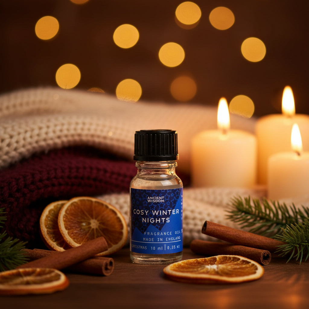Cosy Winter Nights Essential Oil 10ml displayed with festive decorations, featuring slices of orange, cinnamon sticks, and candles, perfect as a Christmas gift or stocking filler for those seeking a relaxing winter spice aroma for their home fragrance and pamper pack. This essential oil captures the essence of cinnamon orange, frankincense myrrh, and white Christmas, making it a delightful choice for aromatherapy.