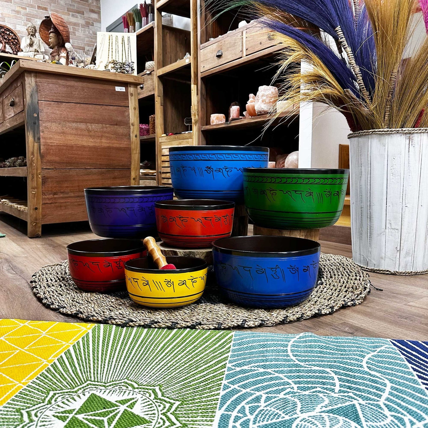 Large 7 Chakra Singing Bowls Set arranged aesthetically among natural decor elements, highlighting the colourful bowls designed to promote spiritual wellness and relaxation, making it a wonderful Christmas gift for a cozy home.