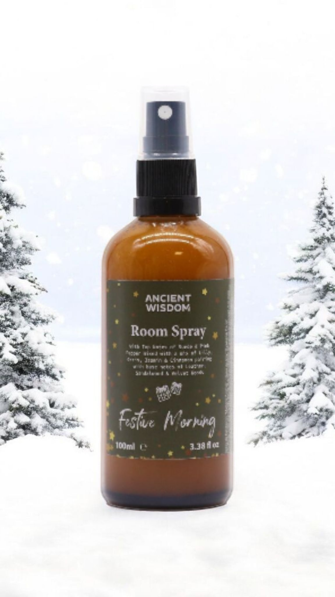 Festive Morning 100ml Christmas Room Spray displayed in a snowy setting, perfect as a Christmas gift or stocking filler. This festive fragrance invites a cozy atmosphere with its warm spice aroma, making it an ideal home fragrance for pampering. Enjoy the notes of winter spice, cinnamon orange, frankincense myrrh, and white Christmas with this delightful aromatherapy spray.