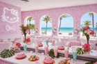 A view inside the Hello Kitty Restaurant Cancun, showcasing a pink-themed decor with a beach view through arched windows, featuring Hello Kitty-designed desserts and drinks, capturing the magical moments at the Hello Kitty Restaurant Cancun.