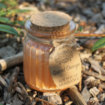 Spiced Orange Soy Candle Pot – Eco-Friendly 20Hr Burn nestled in a rustic setting, enhancing outdoor spaces with its warm aroma, a perfect choice for gifting as a Christmas gift home fragrance.