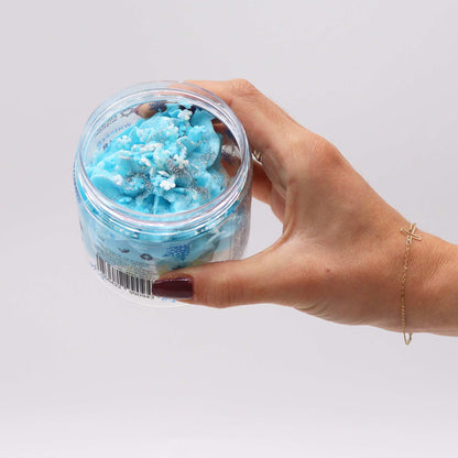 A hand holding the White Christmas Whipped Soap 120g, elegantly designed for at-home pampering during the holiday season, making it a delightful Christmas gift – Christmas Gift Home Fragrance.