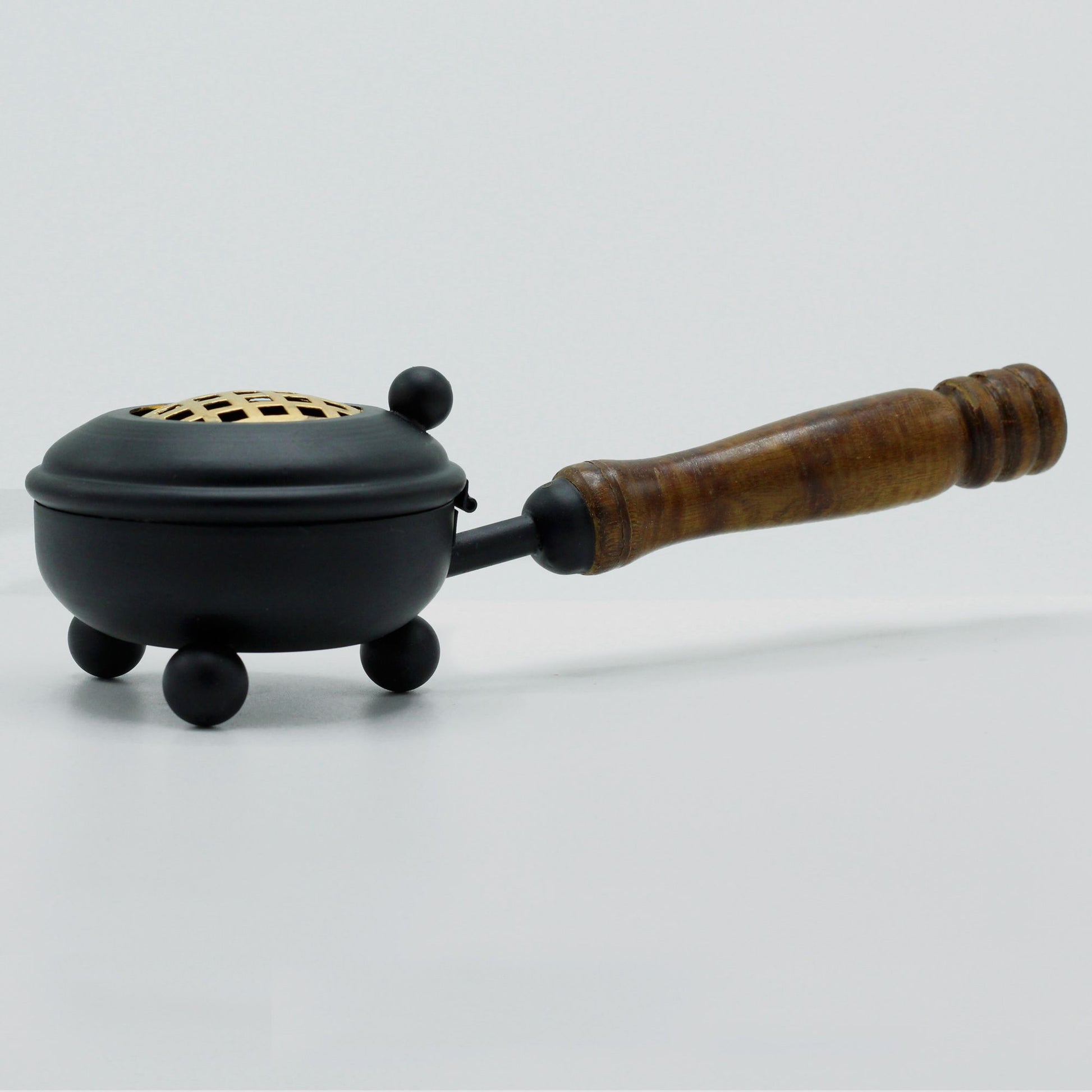 Rustic Cast Iron Incense Burner With Wooden Handle – Gold Accents, displayed elegantly from the side, showcasing its rustic charm and practicality. Excellent for adding fragrance to any space, making it an ideal Christmas Gift Home Fragrance.