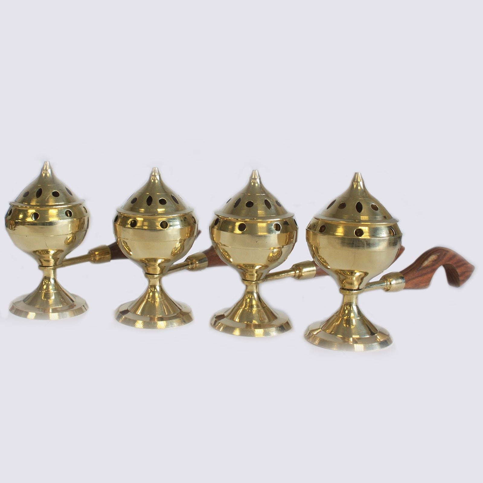 A collection of elegant brass incense burners with wooden handles, showcasing their intricate design, perfect for creating a serene atmosphere. Ideal for home altar and meditation, this Brass Incense Burner is a delightful Christmas gift for home fragrance enthusiasts.