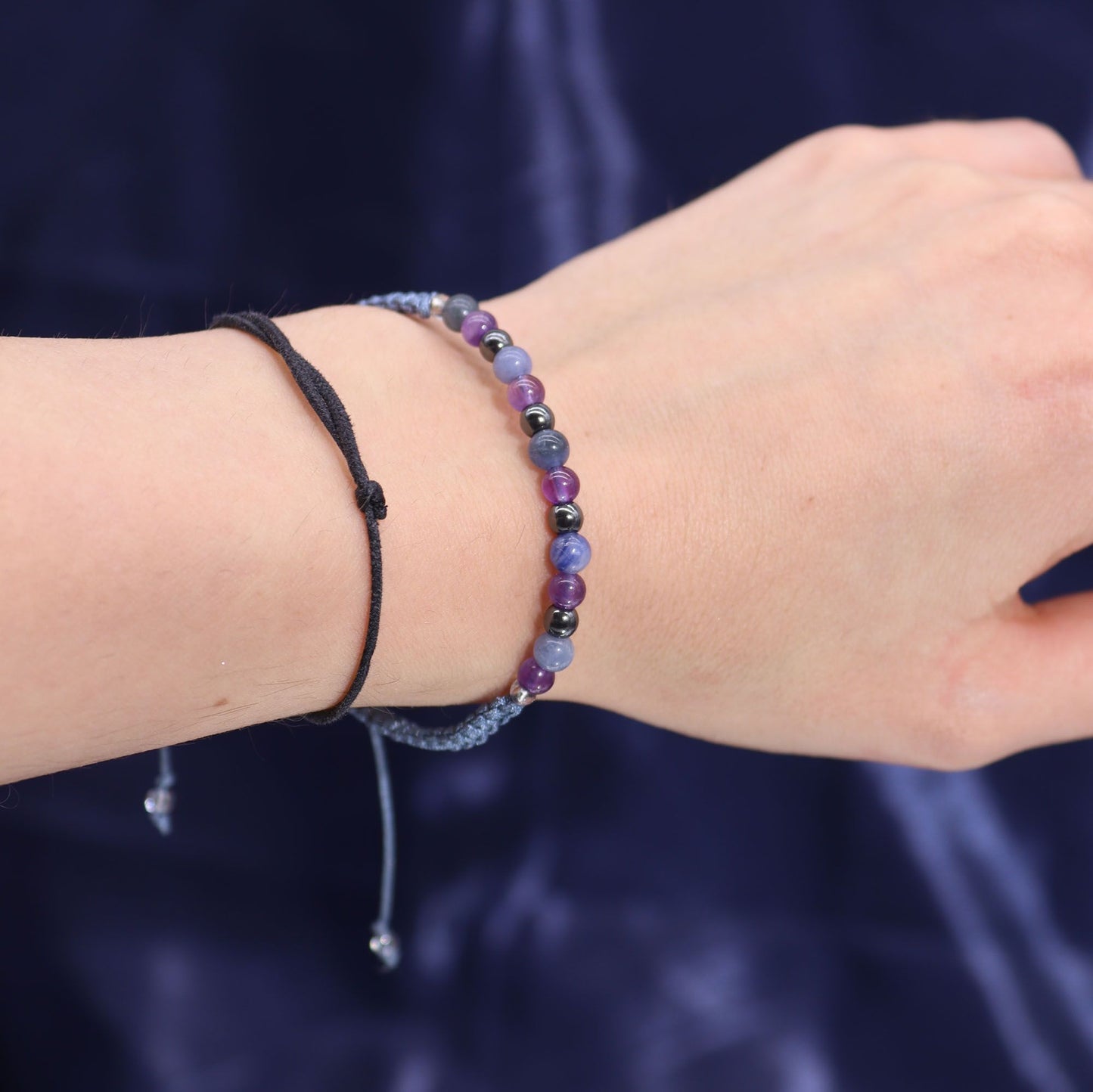 Close-up of the gemstone bracelet included with the Zodiac Crystal Candle with Gemstone Bracelet - Sagittarius, showcasing vibrant amethyst, sodalite, and black obsidian. An ideal Christmas Gift Home Fragrance.