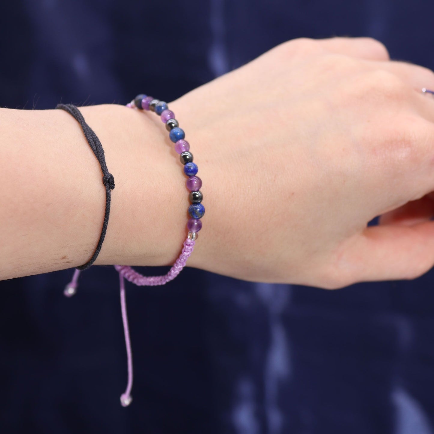 Close-up of the Aquarious Gemstone Bracelet worn on a wrist, highlighting its beautiful amethyst, lapis lazuli, and hematite stones, ideal as a Christmas Gift Home Fragrance.