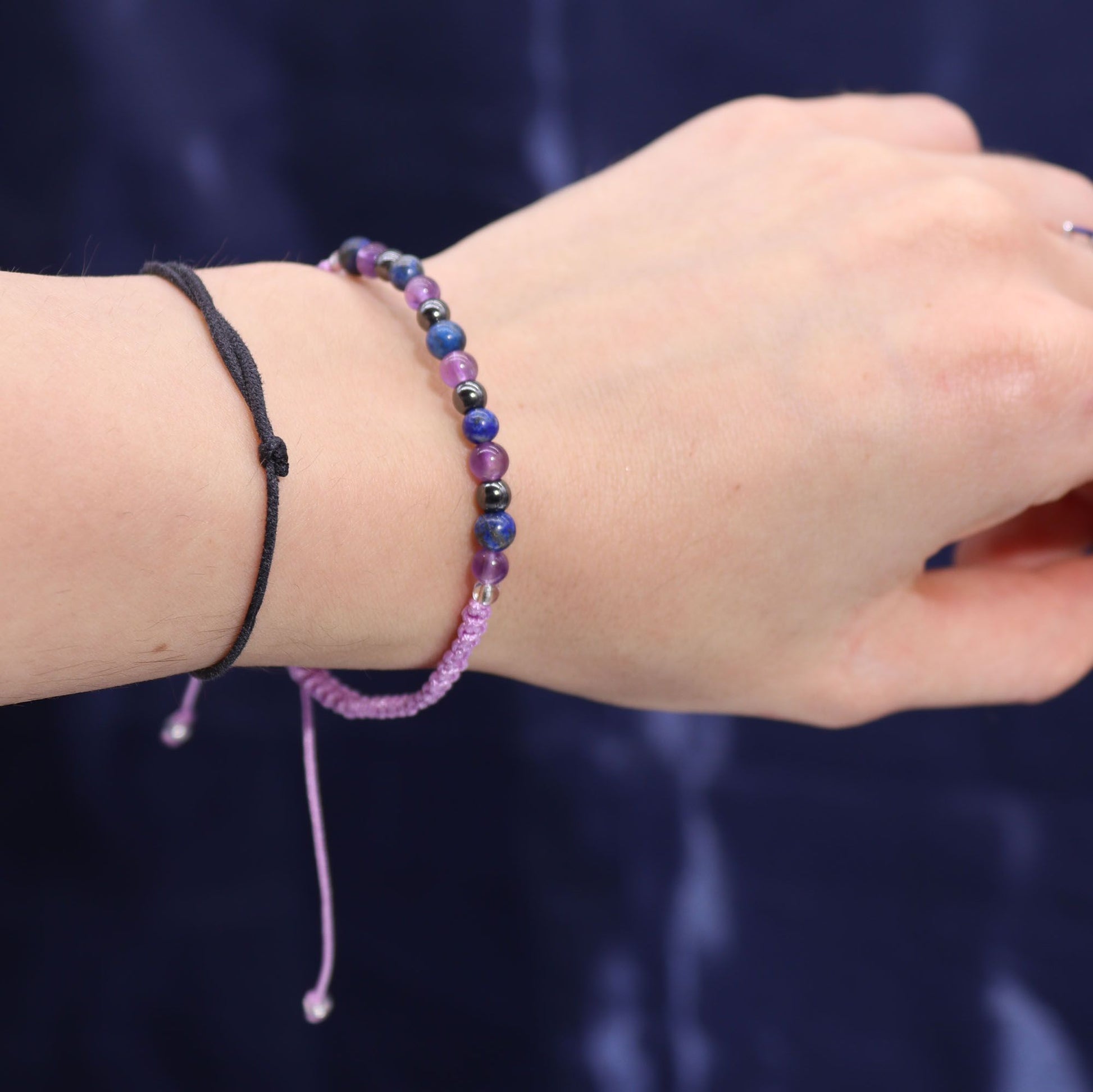Close-up of the Aquarious Gemstone Bracelet worn on a wrist, highlighting its beautiful amethyst, lapis lazuli, and hematite stones, ideal as a Christmas Gift Home Fragrance.