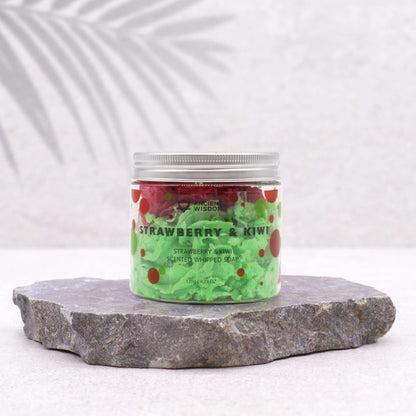 Stylish presentation of Strawberry & Kiwi Whipped Soap 120g – Vegan & Moisturising Luxury on a textured stone surface, highlighting its vibrant colours, ideal for a delightful Christmas gift or home fragrance.