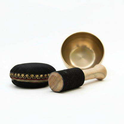 Close-up of the Brass Singing Bowl Set - 9cm Tibetan Gift for Inner Calm highlighting the beautifully crafted bowl and suede stick, ideal for creating soothing sounds during relaxation. This {{scent}} {{product_type}} – Christmas Gift Home Fragrance enhances your wellness routine.