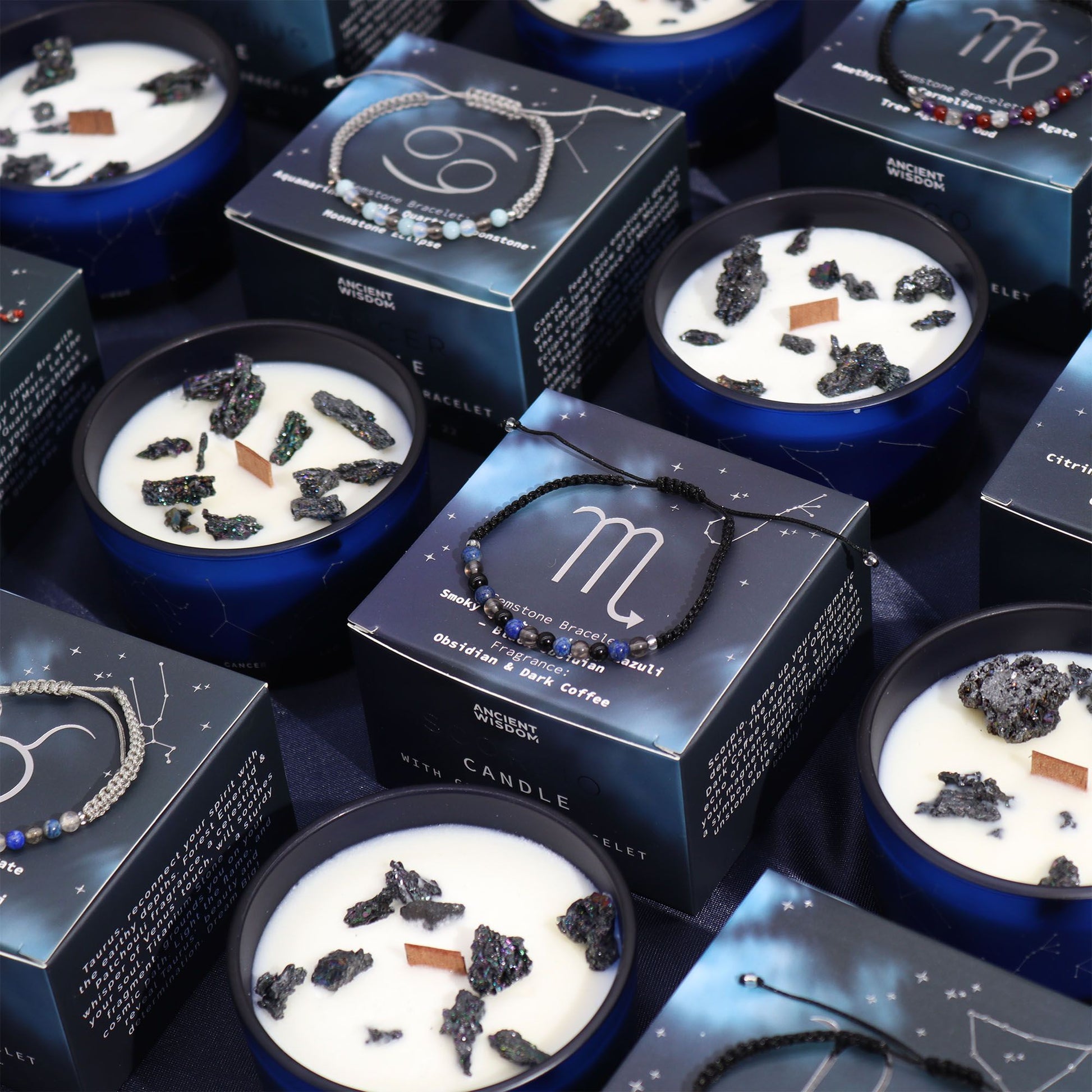 An assortment of Zodiac Crystal Candles with gemstone bracelets displayed elegantly on a table, showcasing their unique candle designs and stunning accessories. This collection features the Zodiac Crystal Candle with Gemstone Bracelet - Capricorn, making it a perfect Christmas gift for home fragrance lovers.