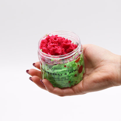 Hand holding the Strawberry & Kiwi Whipped Soap 120g – Vegan & Moisturising Luxury jar, displaying its colourful whipped soap, making it an attractive Christmas gift and indulgent home fragrance.