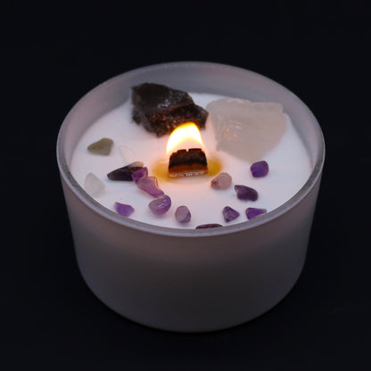 Crown Chakra Candle – Ocean Breeze Scent lit, surrounded by beautiful gemstones, creating a warm glow. Perfect for a calming Christmas Gift Home Fragrance.