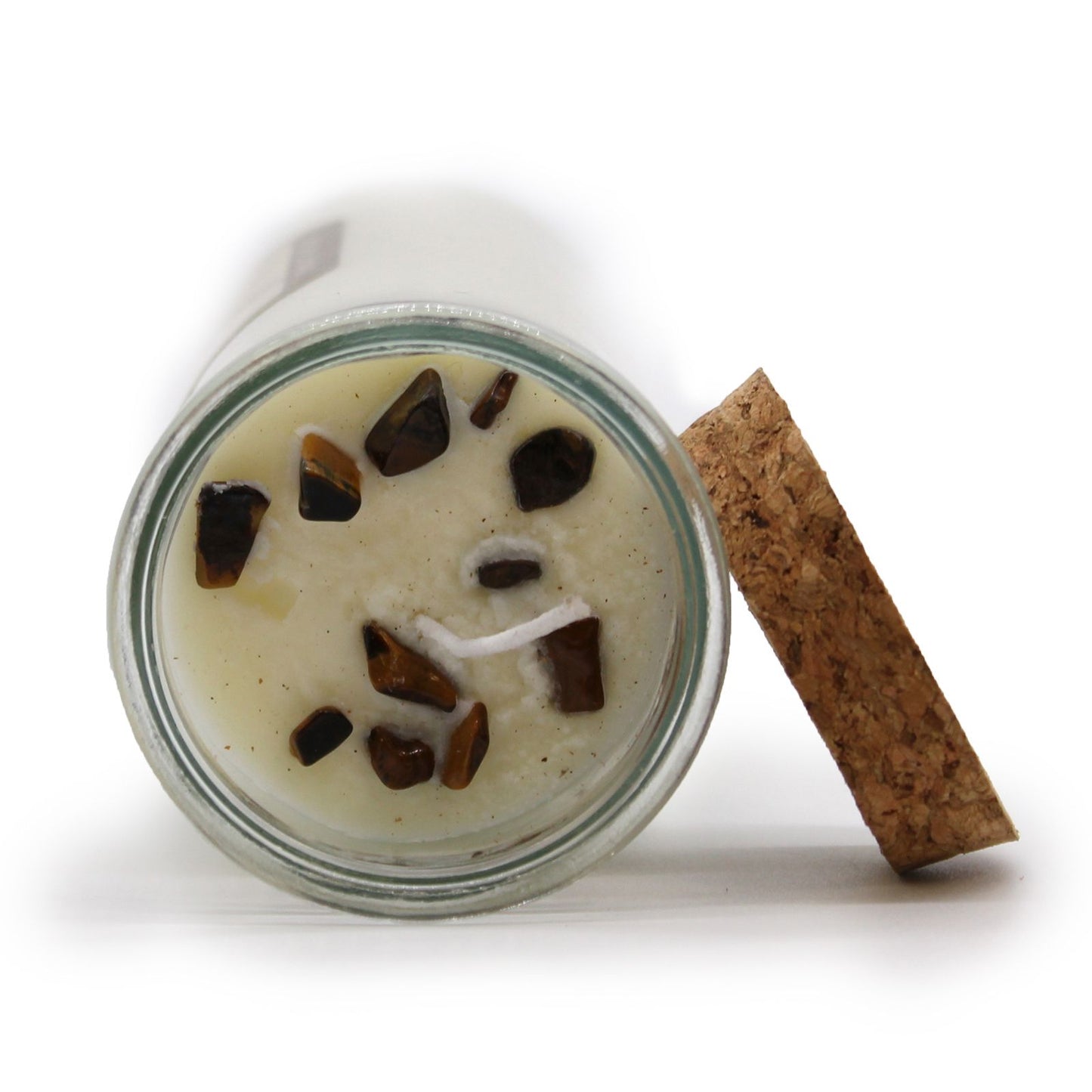 Close-up of Confidence Spell Candle with Tiger Eye & Cinnamon, showing the gemstones embedded in the wax. This unique candle is ideal for enhancing your environment as a Christmas gift home fragrance.