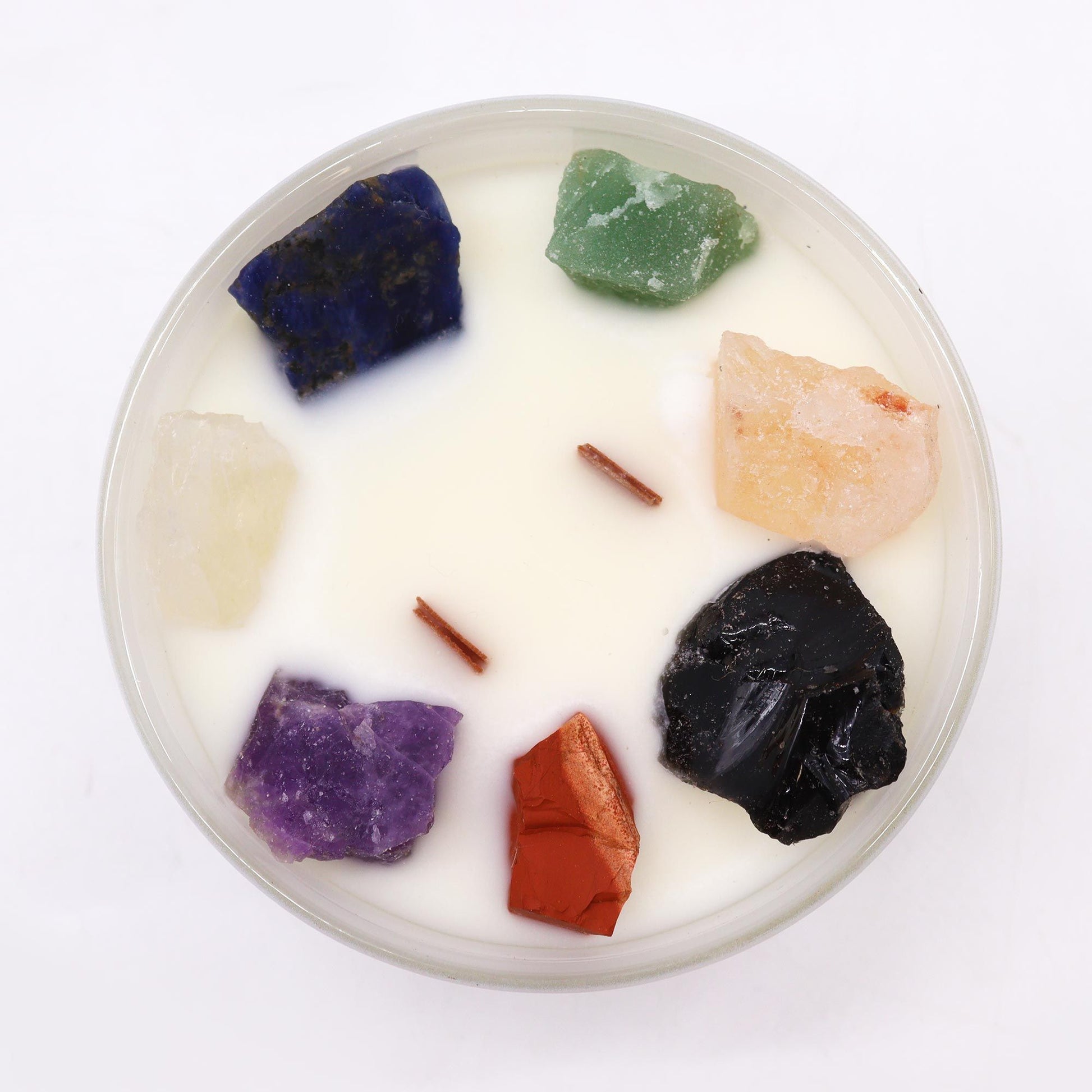 Close-up of the Large Chakra Gemstone Candle - Moon Beams Scent & Light, featuring seven colourful crystals embedded in fragrant wax, ideal for enhancing home fragrance this Christmas.
