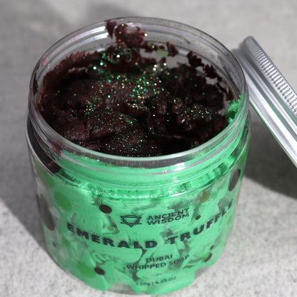 Open jar of Emerald Truffle Whipped Cream Soap, revealing the creamy dark chocolate and green blend, sparkling with glitter—ideal for a lavish pampering session. This enchanting {{scent}} {{product_type}} serves as a delightful Christmas Gift Home Fragrance.