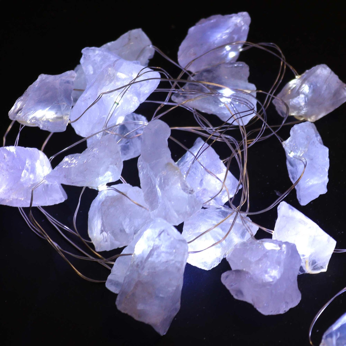 Close-up of Rock Quartz Gemstone Enchantment LED String Lights, highlighting the glowing crystal rocks, perfect for festive decor and Christmas gifting.