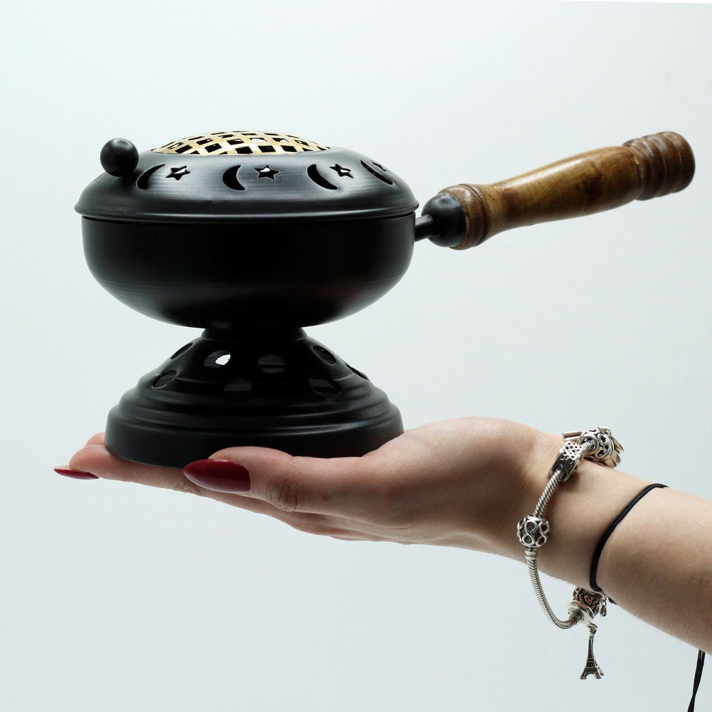 Elegant Iron Censer with Gold Accents held in hand, illustrating its versatility as an effective incense burner—perfect as a Christmas gift for home fragrance enthusiasts.