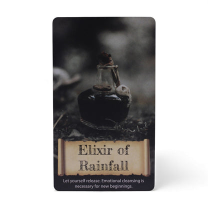 Elixir of Rainfall card from the Crystals & Elixirs Oracle Cards deck, featuring a potion bottle, representing emotional cleansing and new beginnings. Perfect {{scent}} {{product_type}} – Christmas Gift Home Fragrance.
