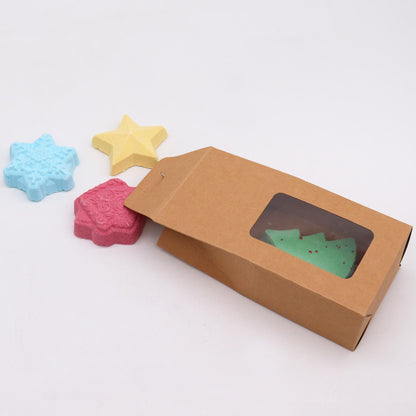 Christmas Wish List Christmas Bath Bomb Gift Pack featuring colourful shaped bath bombs including a green Christmas tree, pink gingerbread house, blue snowflake, and yellow star. Perfect for festive home fragrance and a delightful Christmas gift.