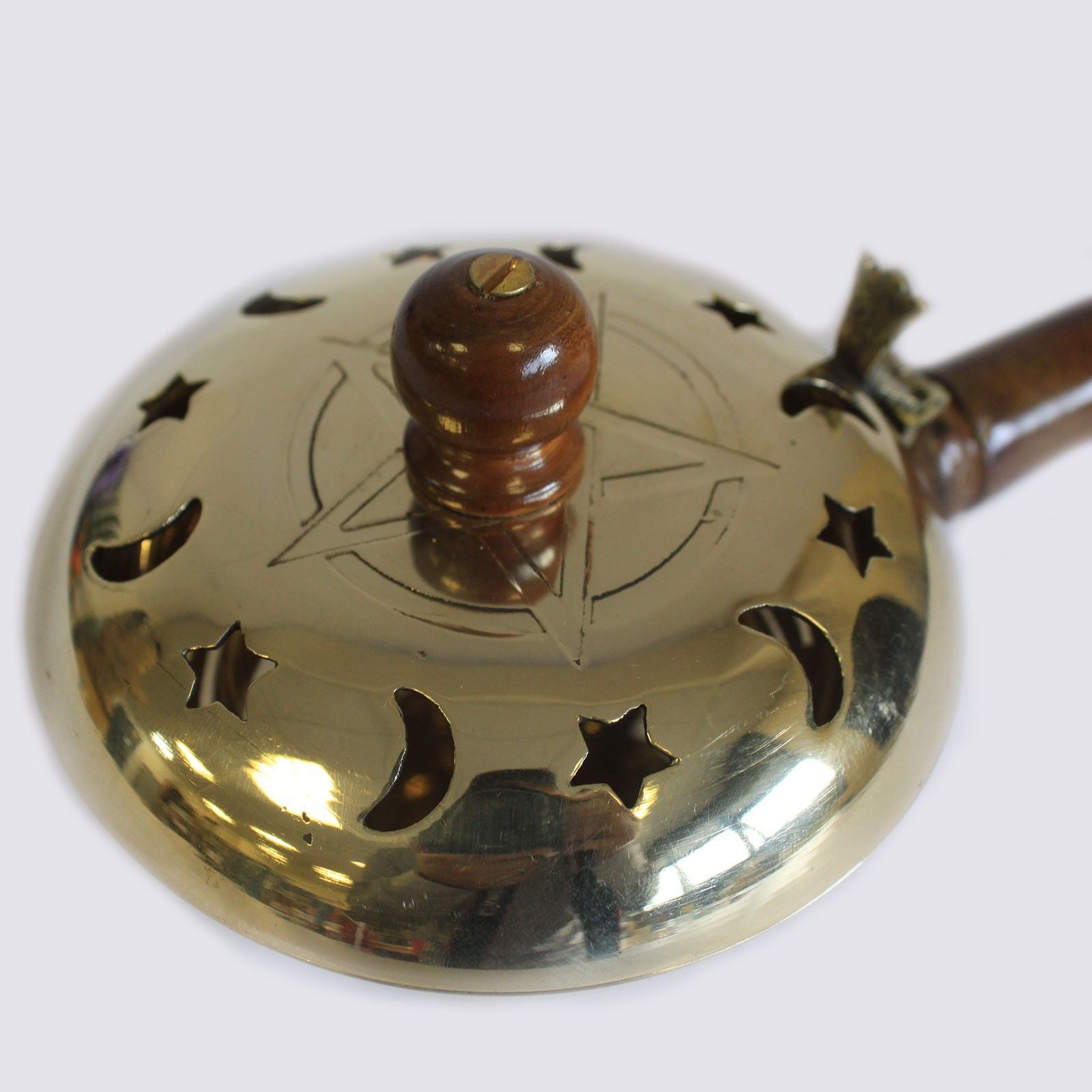 Detailed view of the top of Brass Pentagram Incense Butler with Wooden Handle, featuring the pentagram engraving and celestial design. Perfect for adding charm to your home sanctum – Christmas Gift Home Fragrance