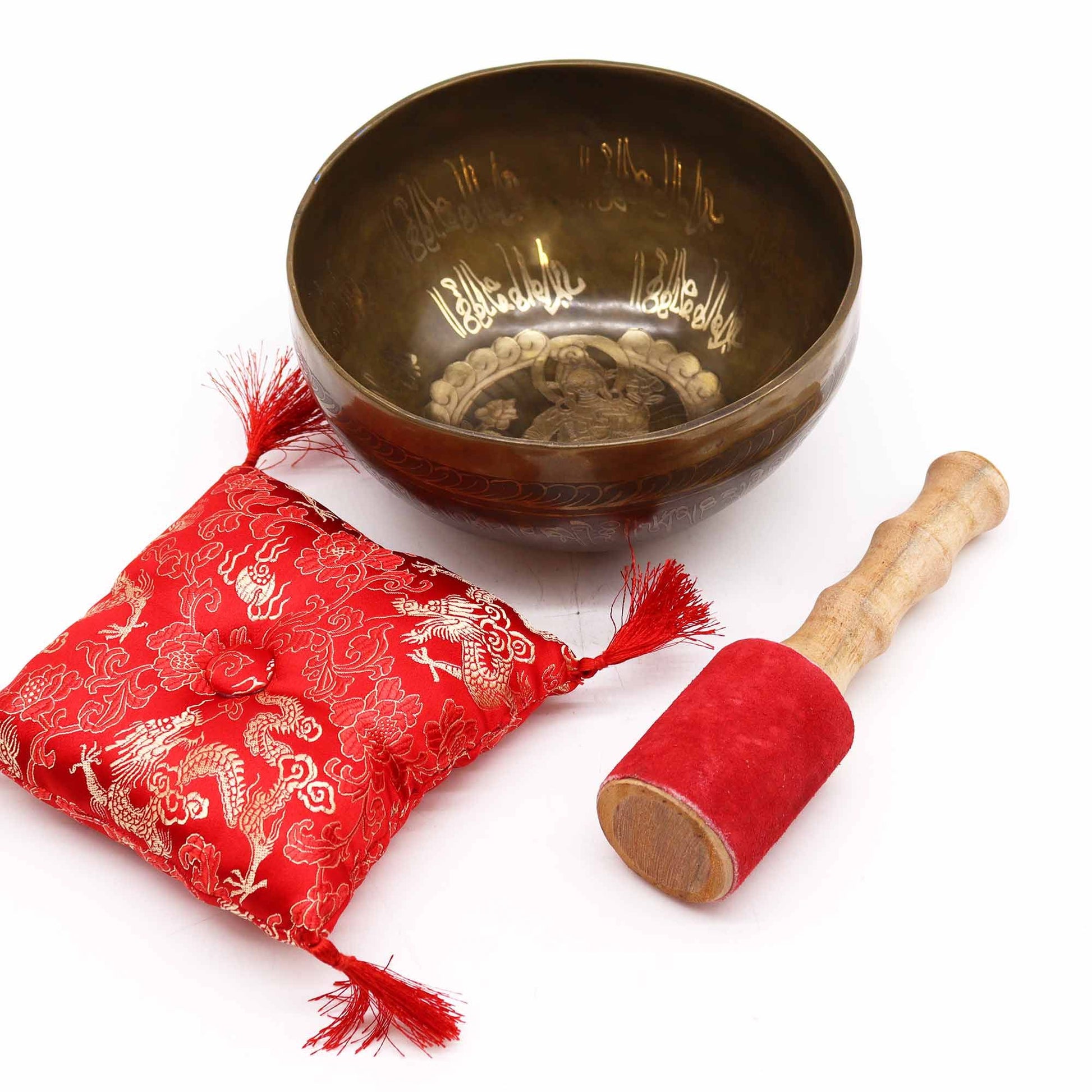 Close-up of the Brass Golden Tara Singing Bowl Gift Set - Tibetan Serenity featuring the beautifully designed bowl alongside a red cushion and stick, ideal for enhancing inner peace. This {{scent}} {{product_type}} – Christmas Gift Home Fragrance is a thoughtful present for mindfulness seekers.
