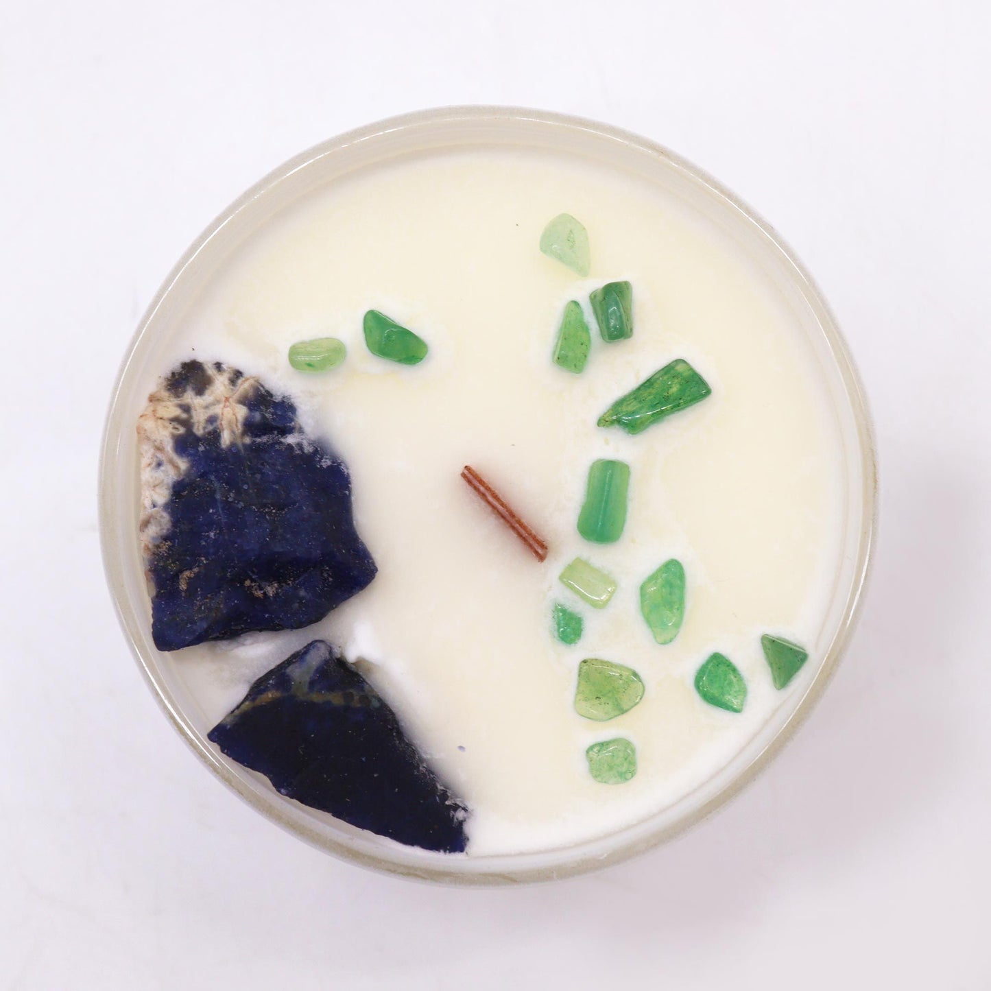 Top view of the Throat Chakra Candle with Sodalite & Jade chips. The calming scent of Gentle Reasons makes this candle an ideal {{scent}} {{product_type}}, perfect for Christmas gifting or home ambience.
