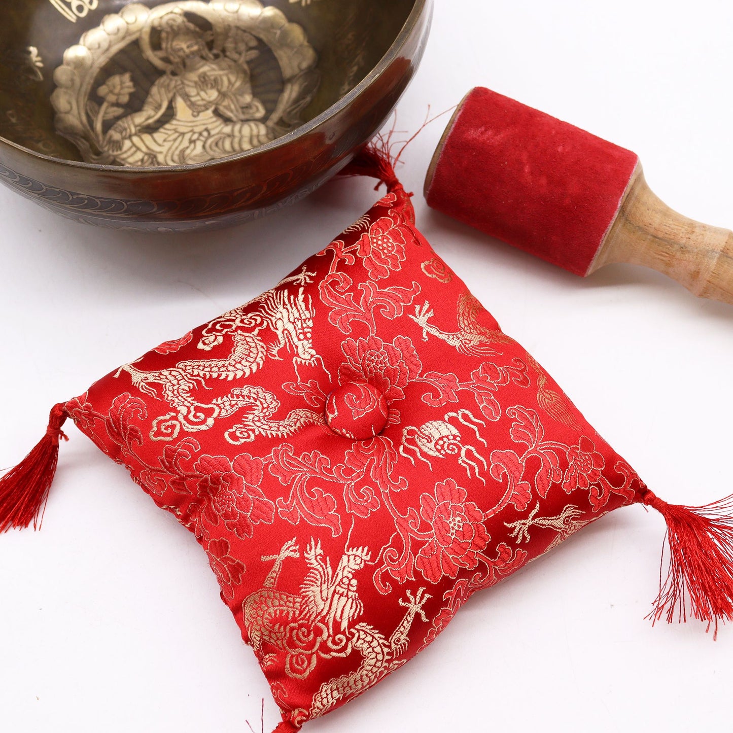 The Brass Golden Tara Singing Bowl Gift Set - Tibetan Serenity with an emphasis on the intricate red cushion and suede stick, enhancing meditation experiences. A great {{scent}} {{product_type}} – Christmas Gift Home Fragrance for a calm and serene environment.