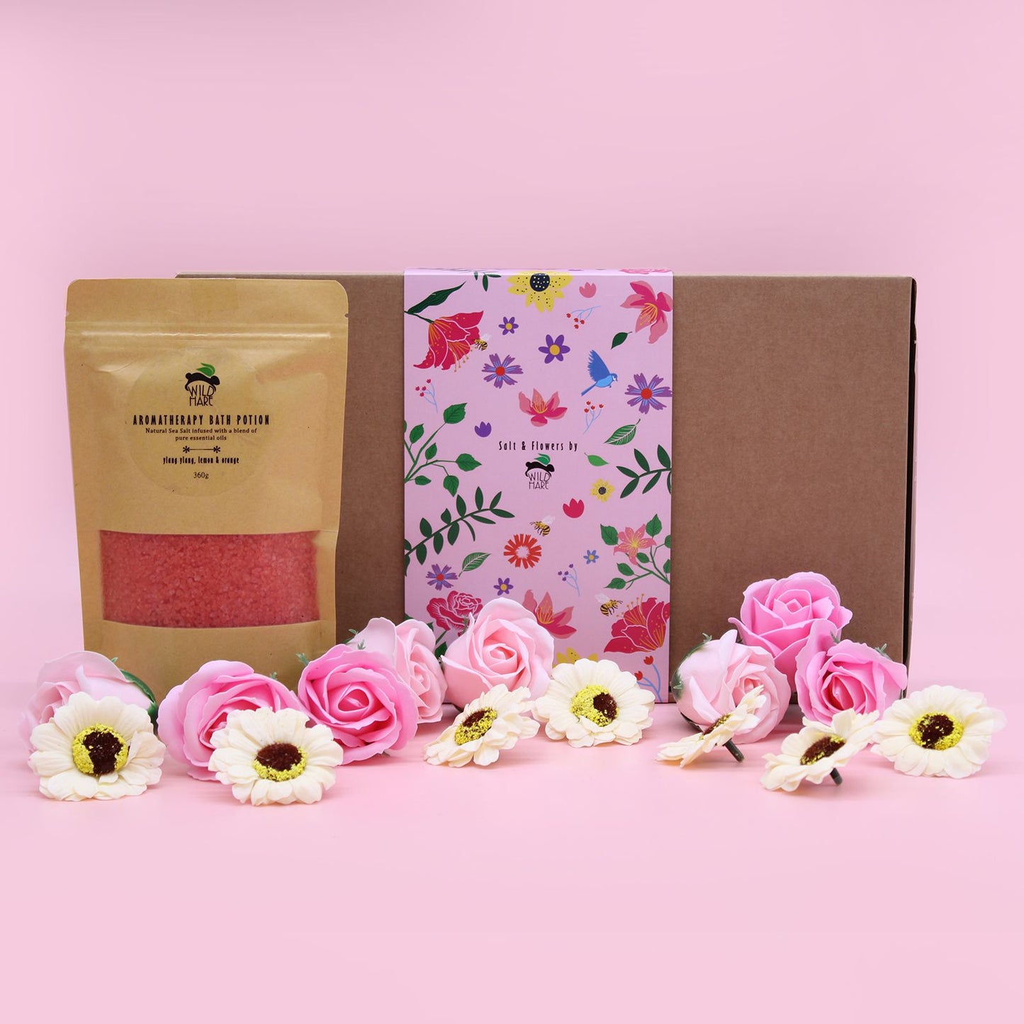 Attractive display of Ylang Ylang & Citrus Bath Salt Set alongside floral soap roses in a cheerful pink setting, perfect for gifting or self-pampering – Christmas Gift Home Fragrance