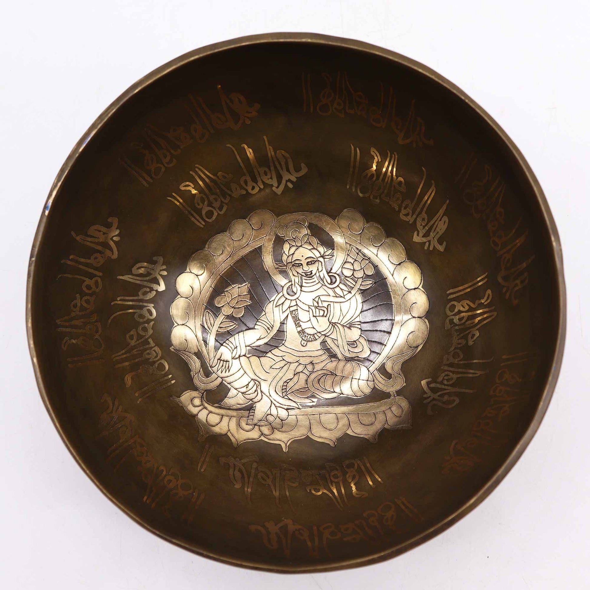 Top view of the Brass Golden Tara Singing Bowl Gift Set - Tibetan Serenity, showcasing detailed inscriptions and a serene image inside, perfect for creating soothing sounds. This {{scent}} {{product_type}} – Christmas Gift Home Fragrance promotes relaxation and mindfulness.