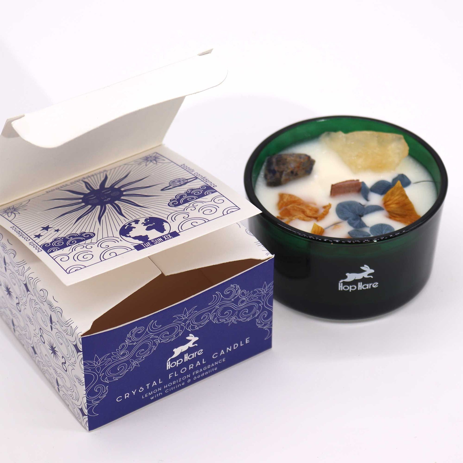 Open box of Hop Hare Crystal Magic Flower Candle revealing the enchanting candle with Citrine and Sodalite. Ideal for adding a unique fragrance touch to your Christmas gifts at home.