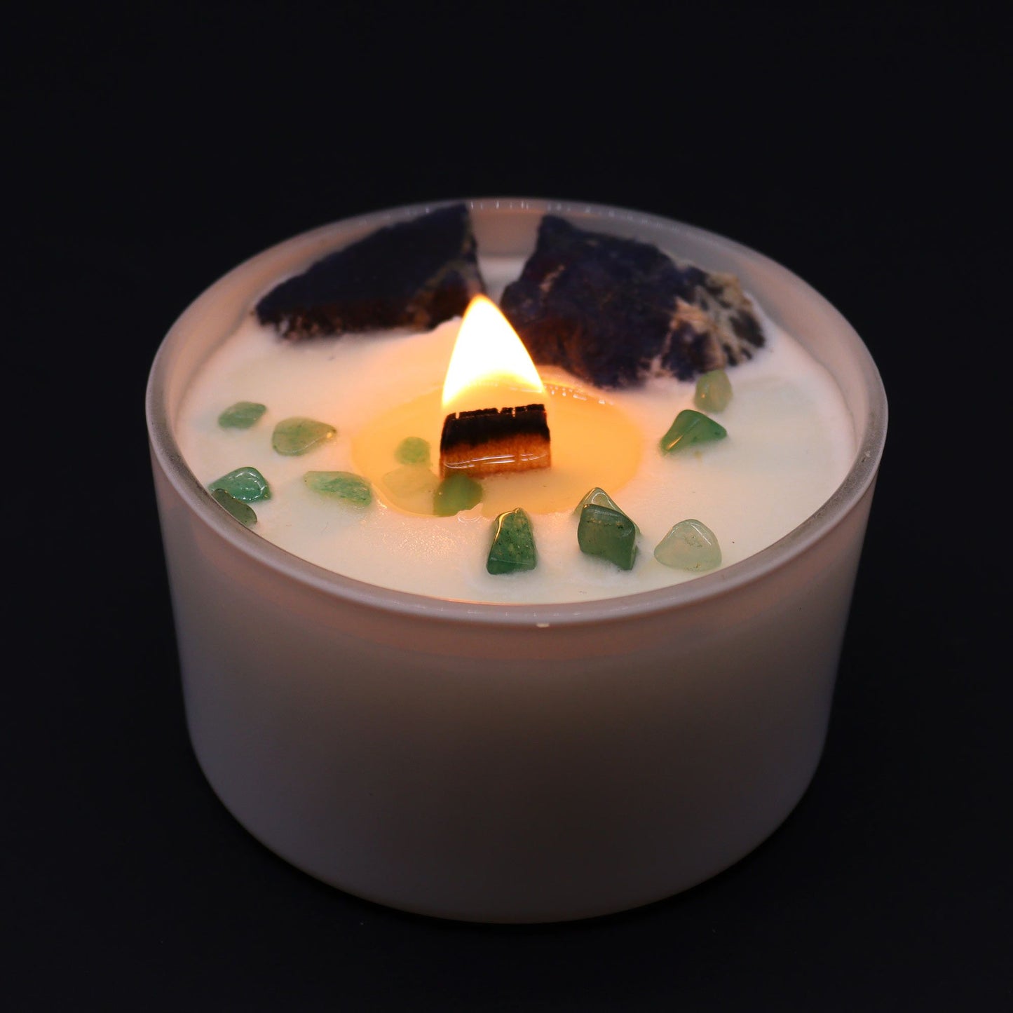 Throat Chakra Candle with Sodalite & Jade lit, emphasizing its calming glow. An ideal {{scent}} {{product_type}} for enhancing home relaxation and perfect for Christmas gifting.