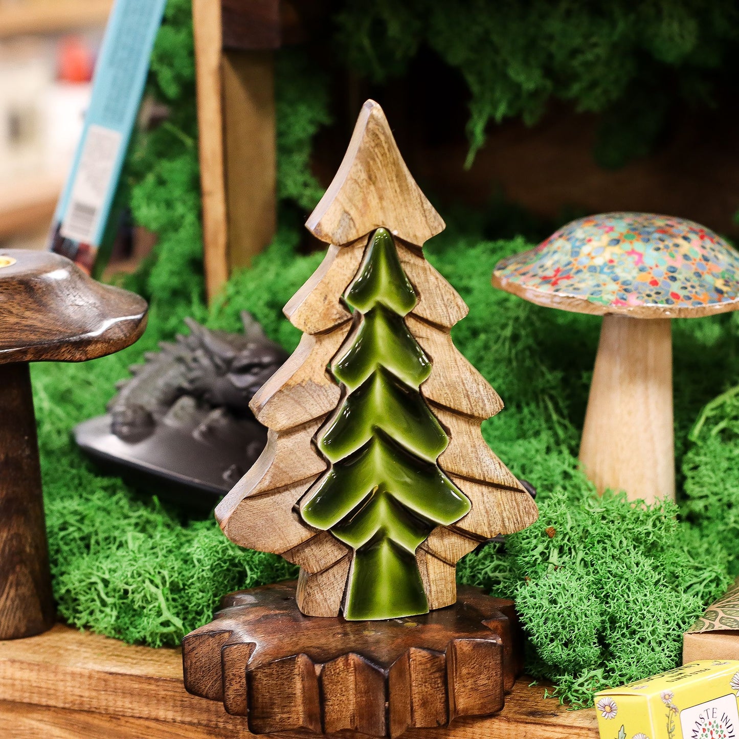 Woodland Charm - Small Tree in Tree Decoration 15x10cm beautifully displayed among greenery, ideal for enhancing your Christmas gift home fragrance theme.