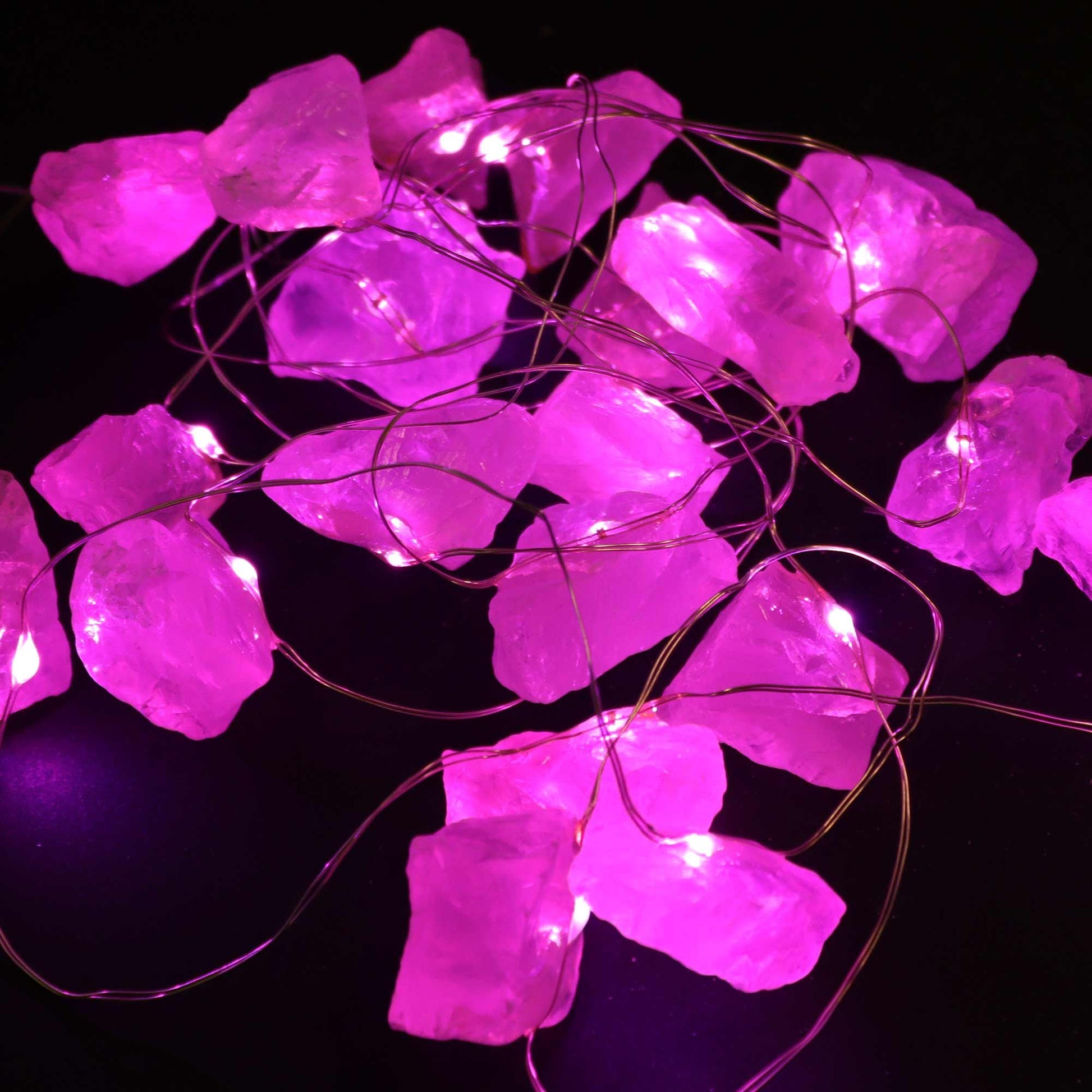 These enchanting Rose Quartz Gemstone Enchantment Lights illuminated, showcasing vibrant pink hues that create a magical ambiance, perfect for Christmas gifting or home adornment.