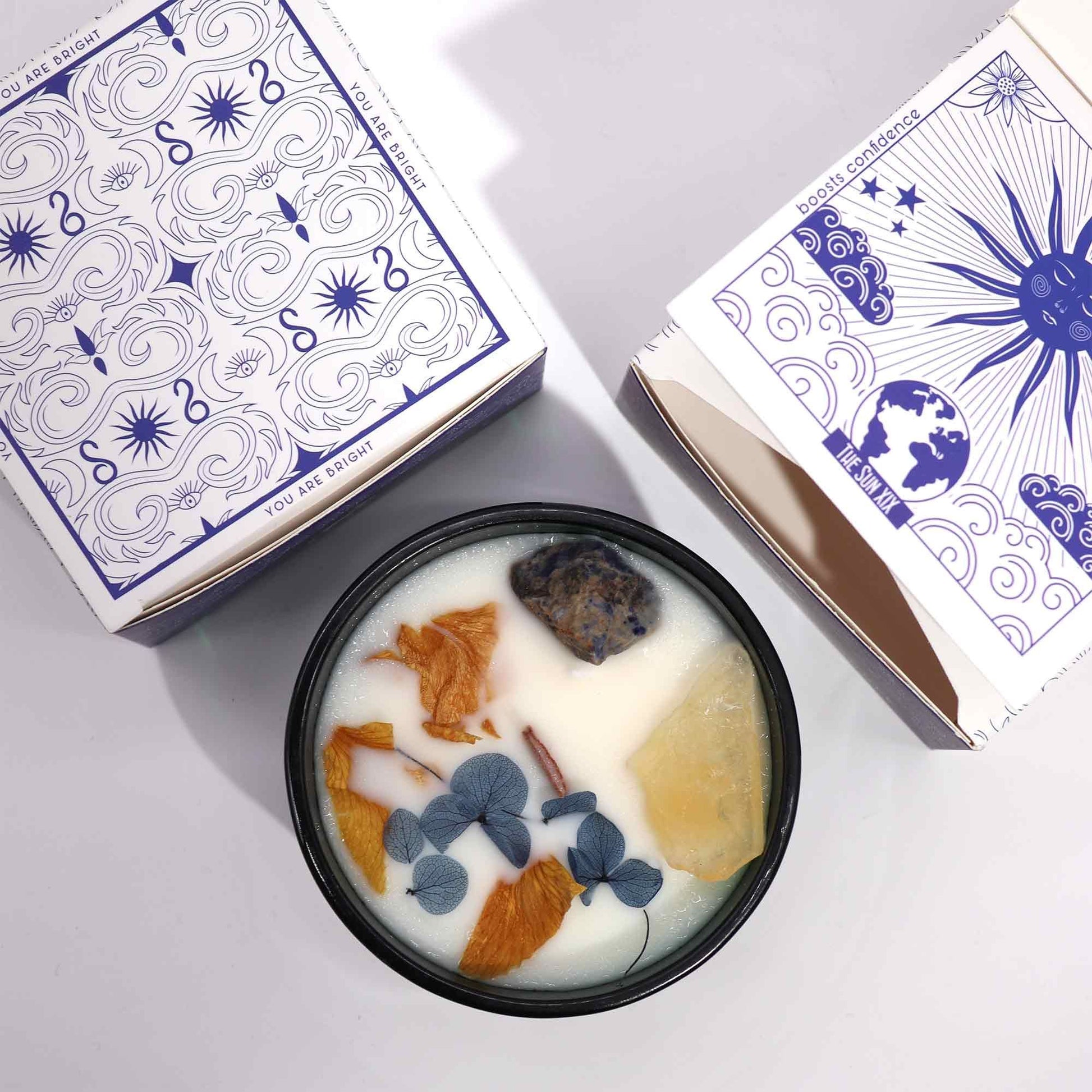 Artistic view of Hop Hare Crystal Magic Flower Candle beside its stylish box, featuring Citrine and Sodalite. A perfect choice for a soothing Christmas gift home fragrance.