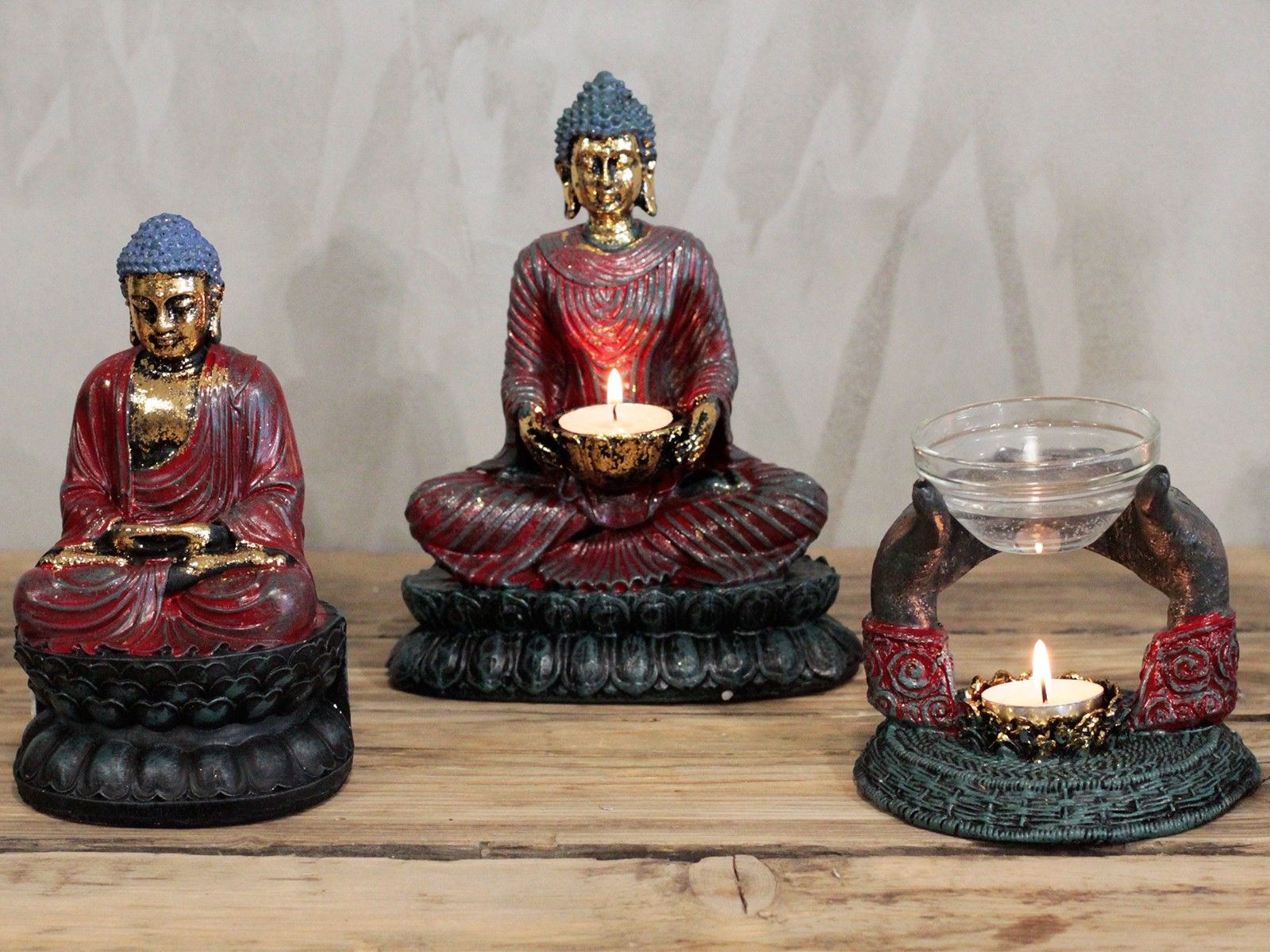 Antique Buddha Candle Holder featuring three decorative Buddha figures and a unique holder on a wooden surface, perfect for creating a serene atmosphere. Ideal for meditation spaces, this piece makes a thoughtful Christmas gift while enhancing your home fragrance and decor.