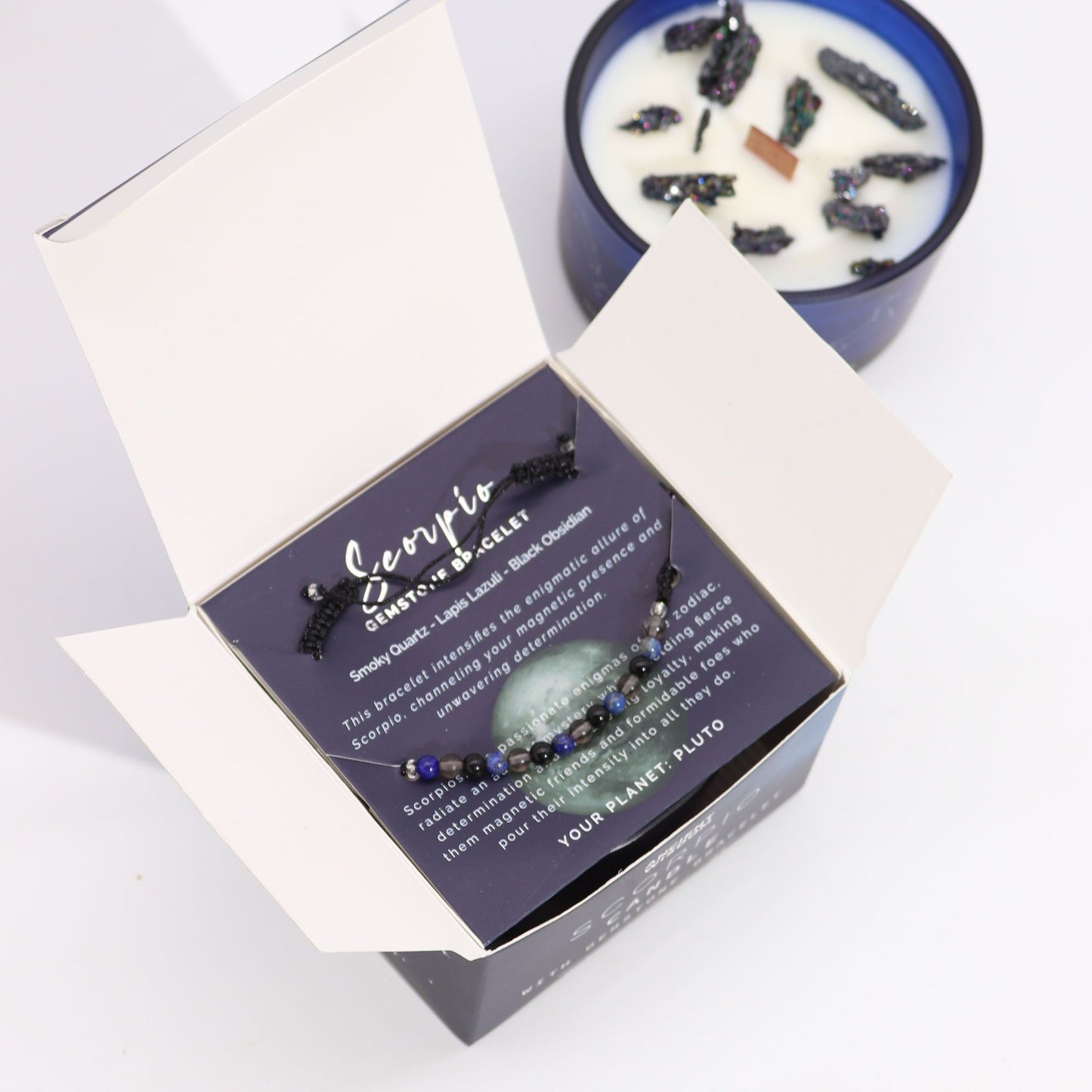 Inside view of the Scorpio Zodiac Crystal Candle with Gemstone Bracelet set, highlighting the unique gemstones and informative card. This enchanting scent makes a thoughtful Christmas Gift Home Fragrance.