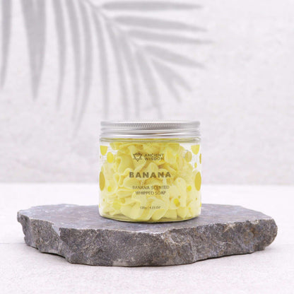 Banana Whipped Soap 120g in a clear jar on a textured surface, perfect for a vegan, cruelty-free bath treat. Ideal for Christmas Gift Home Fragrance with a delightful scent.