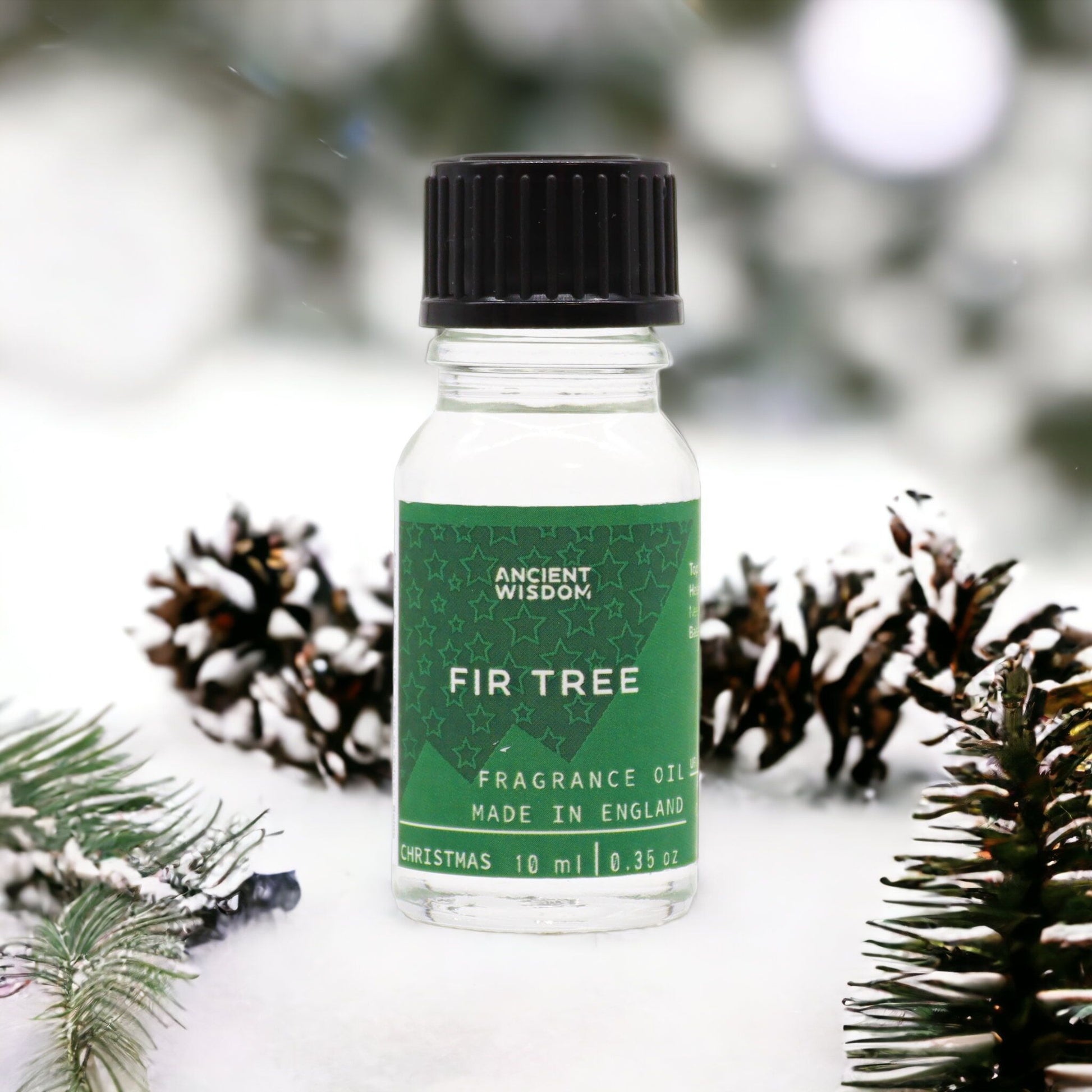 Fir Tree Fragrance Oil 10ml displayed with pine cones in a snowy setting, a delightful choice for home fragrance enthusiasts. This festive fragrance makes a wonderful Christmas gift or stocking filler, embodying the spirit of winter spice and aromatherapy.