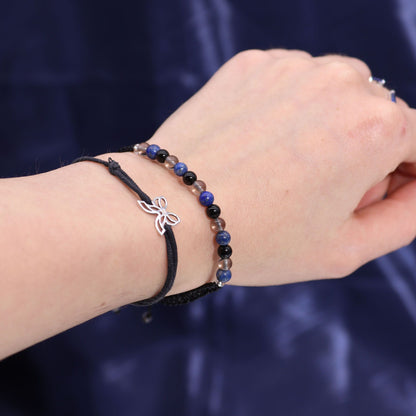 Close-up of the Scorpio Gemstone Bracelet on a wrist, beautifully crafted with smoky quartz and lapis lazuli, enhancing its charm. Perfect pairing with the Zodiac Crystal Candle for a lovely Christmas Gift Home Fragrance.