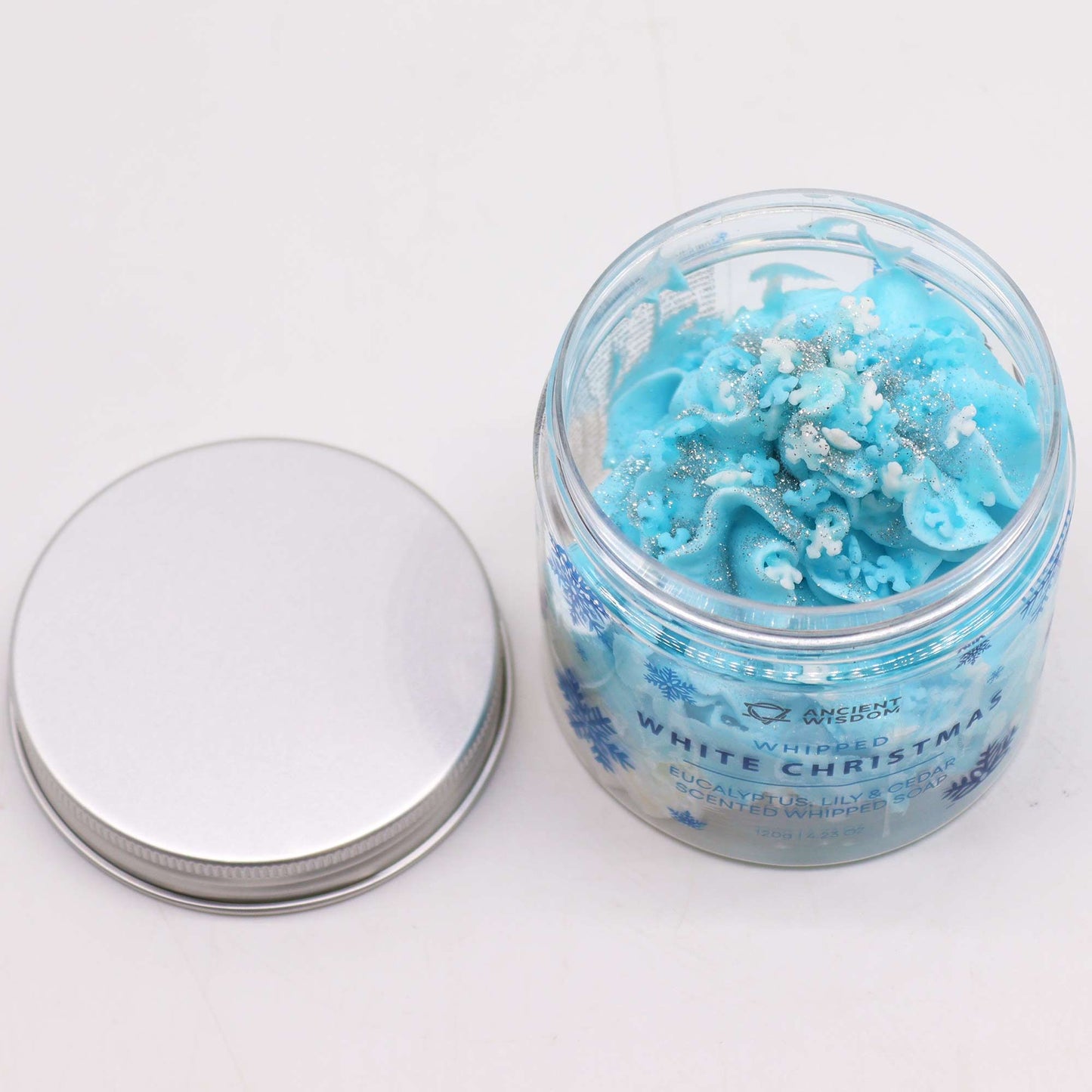Top view of the White Christmas Whipped Soap 120g, highlighting the creamy blue texture adorned with snowflake decorations, ideal for a cheerful holiday bathing ritual – Christmas Gift Home Fragrance.