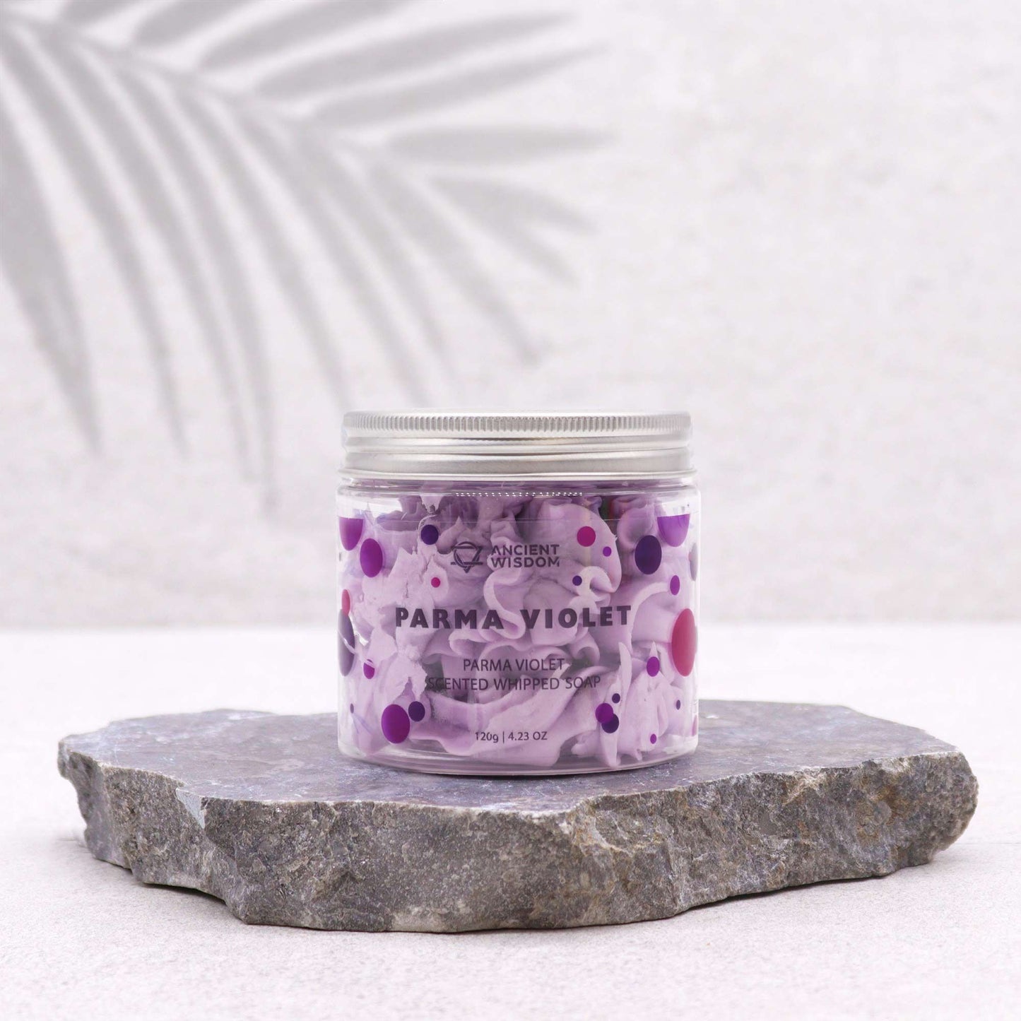 Parma Violet Whipped Soap 120g – Luxurious Vegan Bath Indulgence displayed on a grey stone surface, highlighting the unique whipped consistency and vibrant colours. Ideal as a {{scent}} {{product_type}}, it makes a wonderful Christmas gift for a fragrant home.