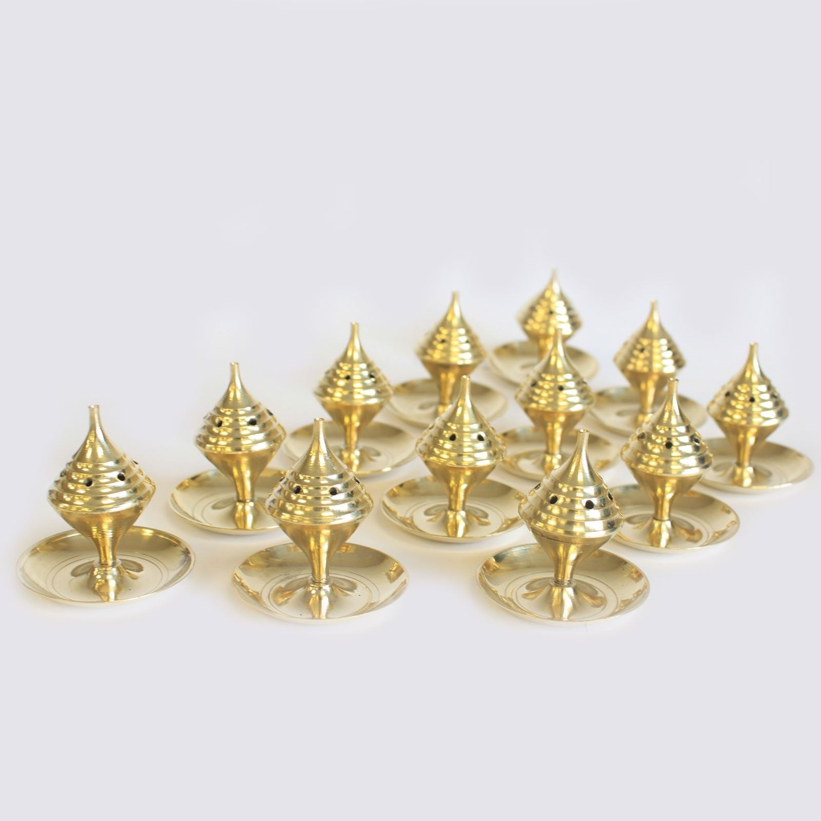 Collection of Small Brass Incense Burners - Elegant Design for Meditation arranged in a group, showcasing their shiny brass finish. These burners are perfect for gifting during the festive season, ensuring a lovely home fragrance experience as a Christmas gift.