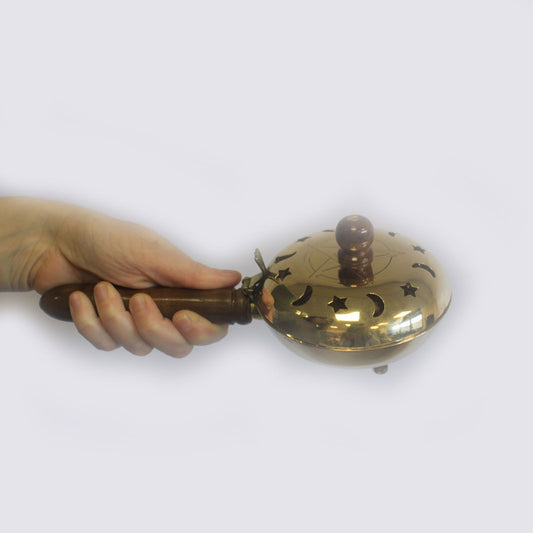 Brass Pentagram Incense Butler with Wooden Handle showcased in a hand, perfect for enhancing your sacred space. This unique {{scent}} {{product_type}} is an ideal Christmas Gift for those who appreciate home fragrance.