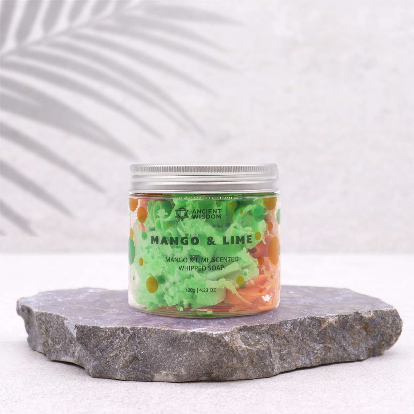 Tropical Mango & Lime Whipped Soap 120g presented in a clear jar, showcasing its vibrant green and orange colours, perfect for indulging in a tropical experience. Ideal as a Christmas gift, this whipped soap offers delightful mango and lime scents that elevate any home fragrance.