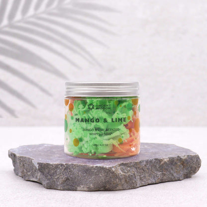 Tropical Mango & Lime Whipped Soap 120g presented in a clear jar, showcasing its vibrant green and orange colours, perfect for indulging in a tropical experience. Ideal as a Christmas gift, this whipped soap offers delightful mango and lime scents that elevate any home fragrance.