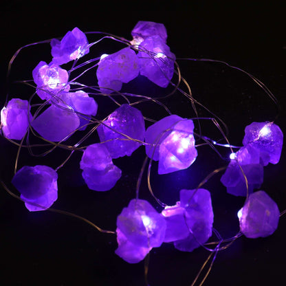 Amethyst Gemstone Enchantment LED String Lights illuminated, displaying a warm purple glow with 20 enchanting crystals, great for enhancing indoor ambiance and making for a charming Christmas gift.
