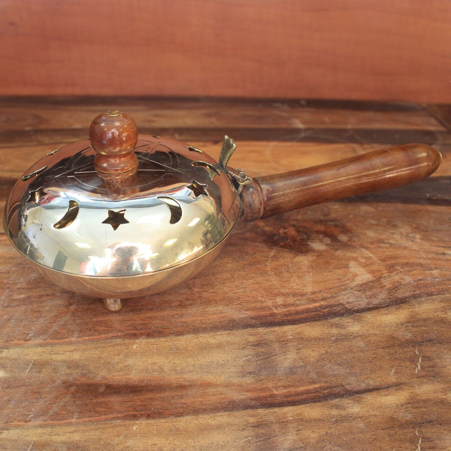 Close-up view of the Brass Pentagram Incense Butler with Wooden Handle, highlighting its elegant design. A great choice for adding charm to your rituals, this {{scent}} {{product_type}} makes a delightful Christmas Gift for home fragrance lovers.